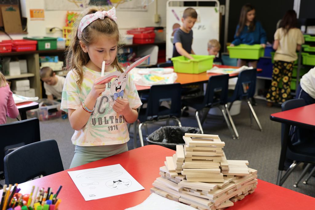 A Broadway student works on a craft during library time.  