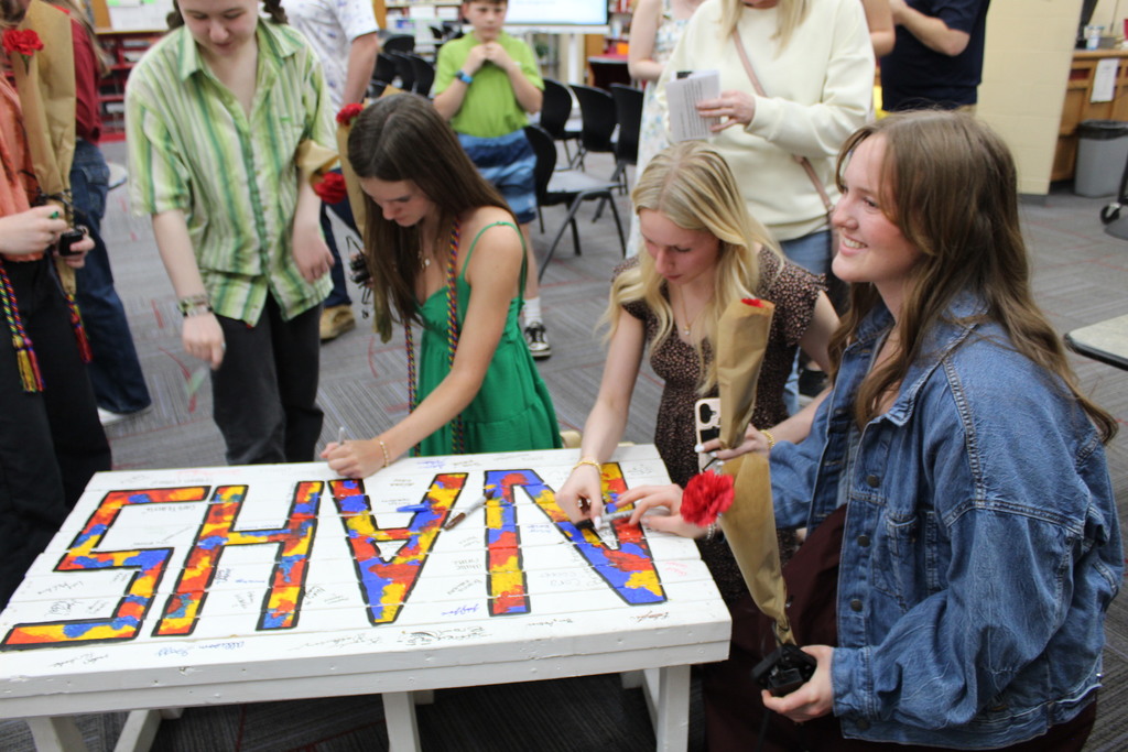 NAHS Induction Ceremony at Tippecanoe High School includes students signing the wooded bench.