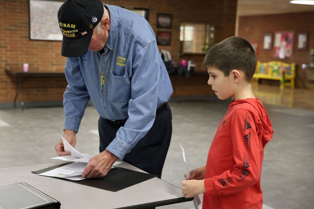 The L.T. Ball students receives paperwork from the veteran he wrote to for an assignment.