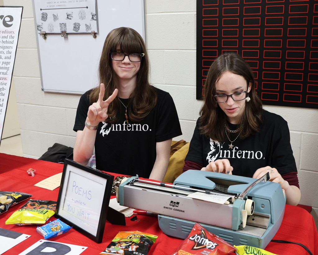 Students from the Inferno encourage people to get a poem written.  