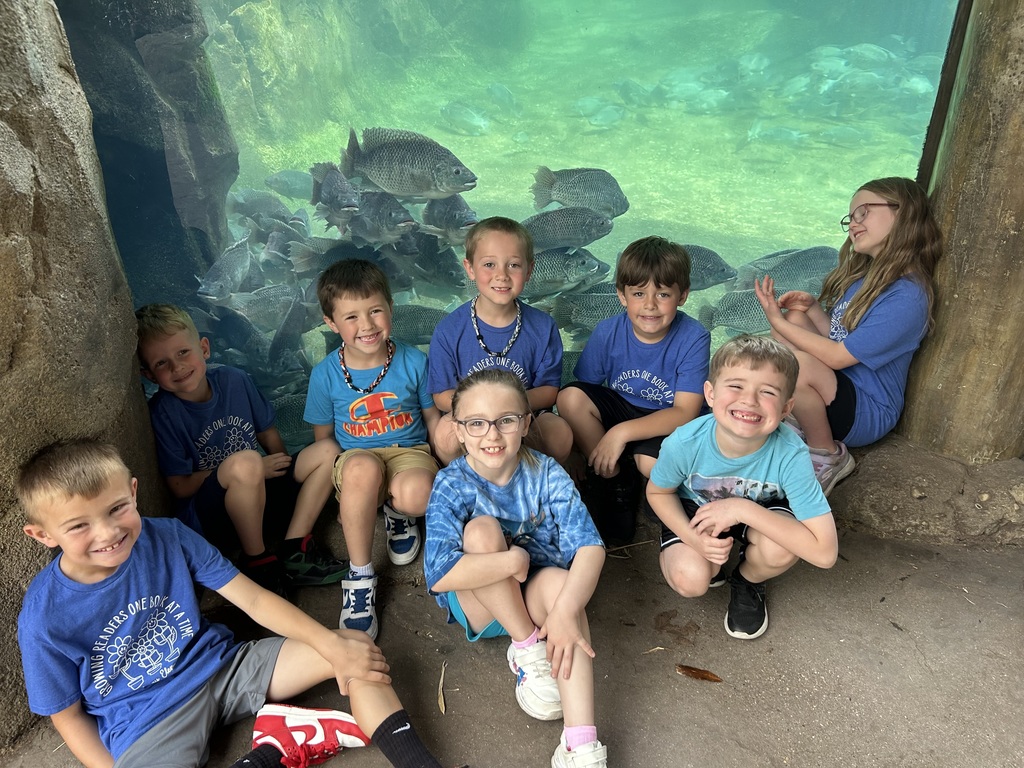 Broadway Elementary students at the Cincinnati Zoo sit.