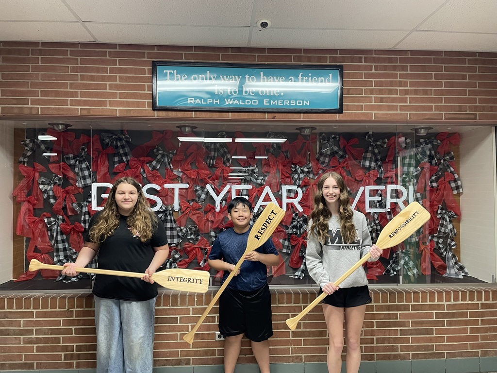 TMS Crew of the Week pose for their picture holding the oars to represent integrity, respect and responsibility.