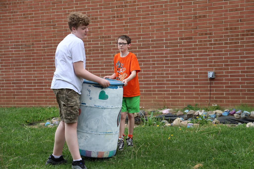 Students carry the water barrel.  