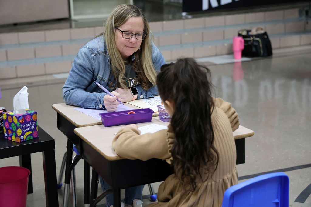 A future Red Devil shows off her skills to a kindergarten teacher during screening.