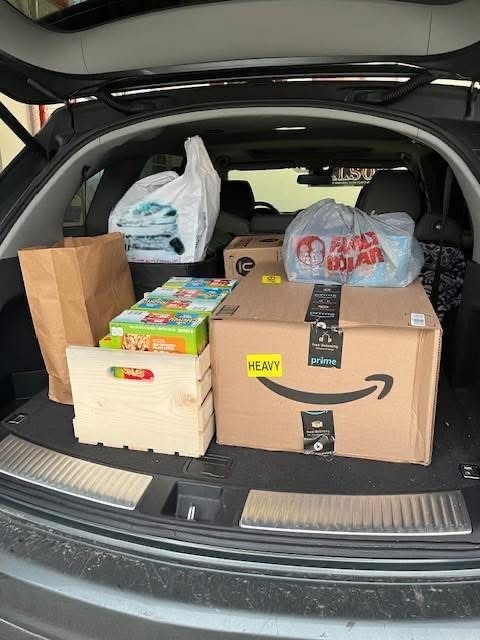 Donations for the TMS Kiwanis Kloset in the back of a car.