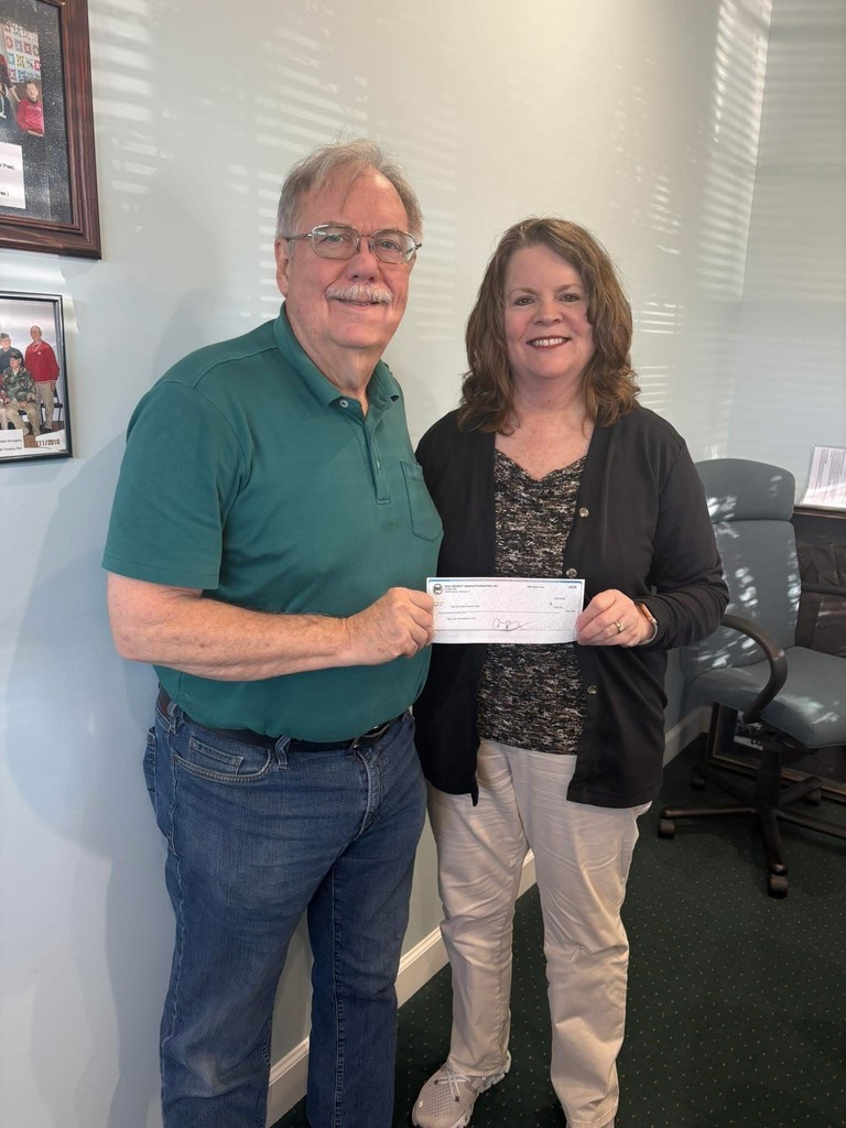 Kiwanis Club members hold a check to be used for TMS Kiwanis Kloset.  