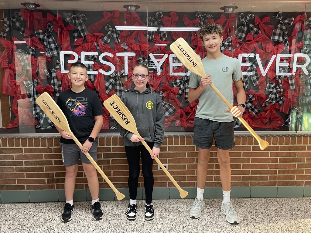 TMS Crew of the Week pose for their picture holding the oars to represent integrity, respect and responsibility.
