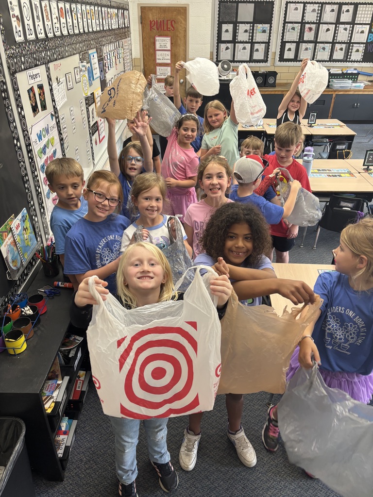 Broadway Elementary students are all smiles as they get ready to go outside with their bags to pick up trash.