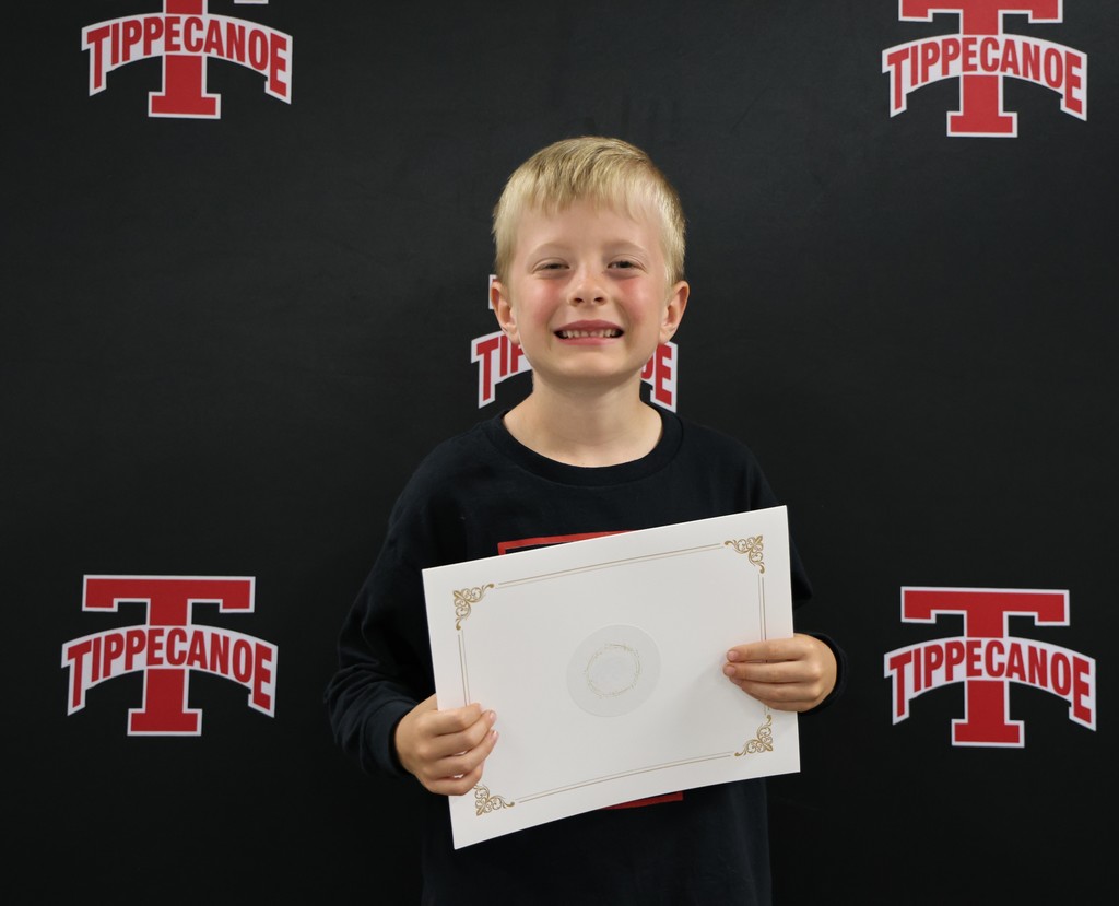 Broadway Elementary kindergarten student holds his certificate after being recognized at the monthly BOE meeting.
