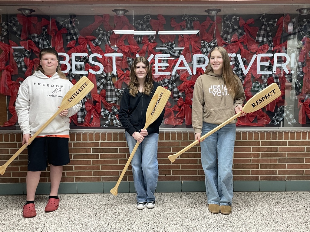 TMS Crew of the Week hold the oars with the words integrity, responsibility, respect.