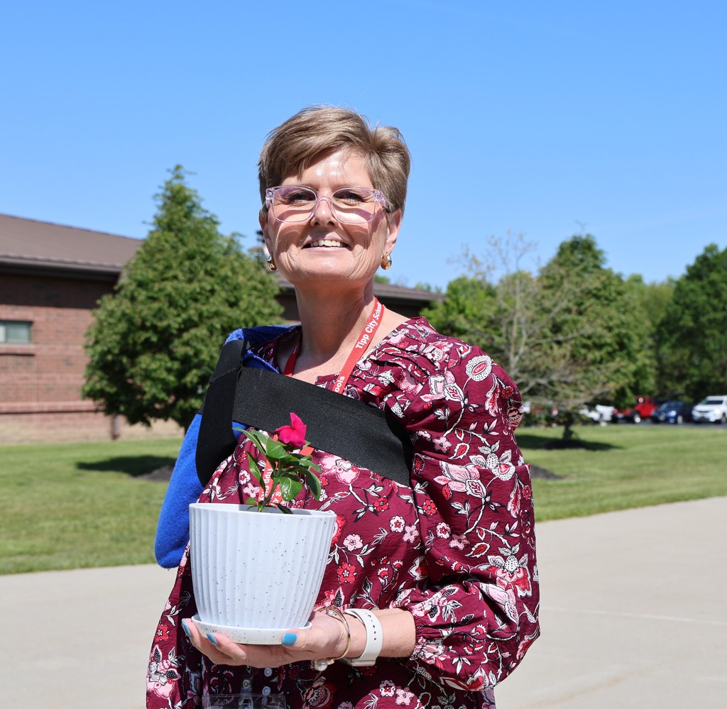 THS staff members planted a flower in a take home flower pot.
