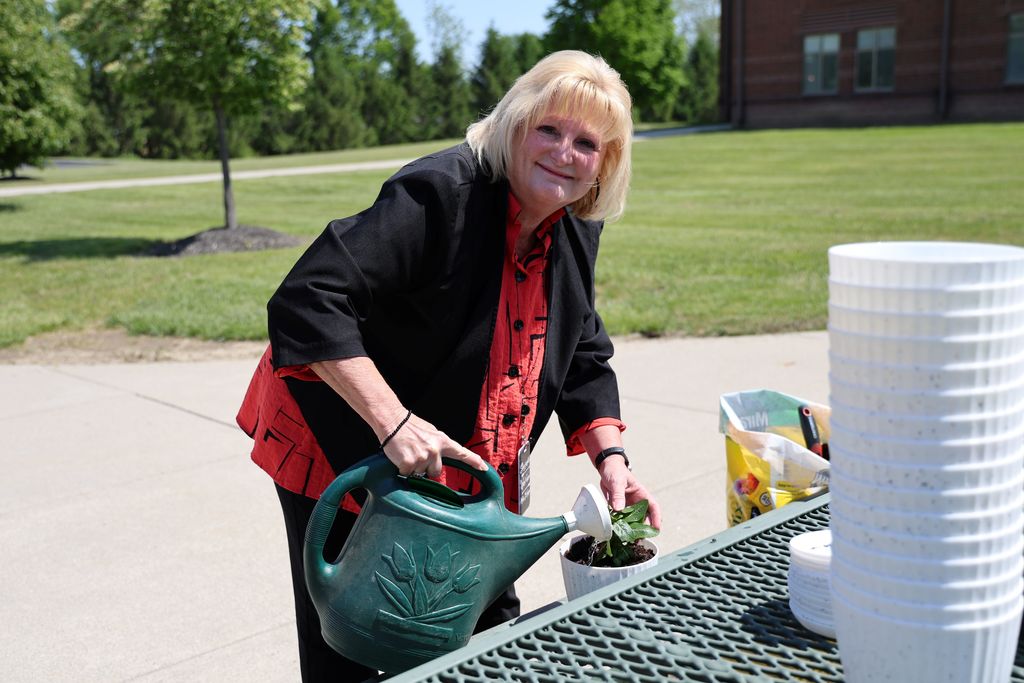 THS staff member waters her new plant.