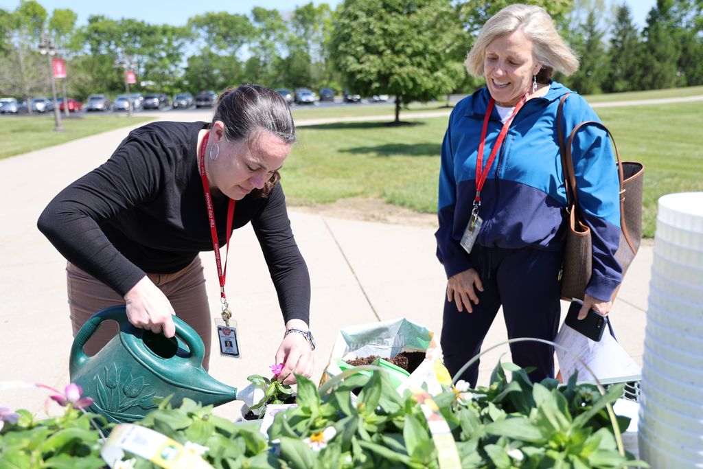 THS staff members planted a flower in a take home flower pot.