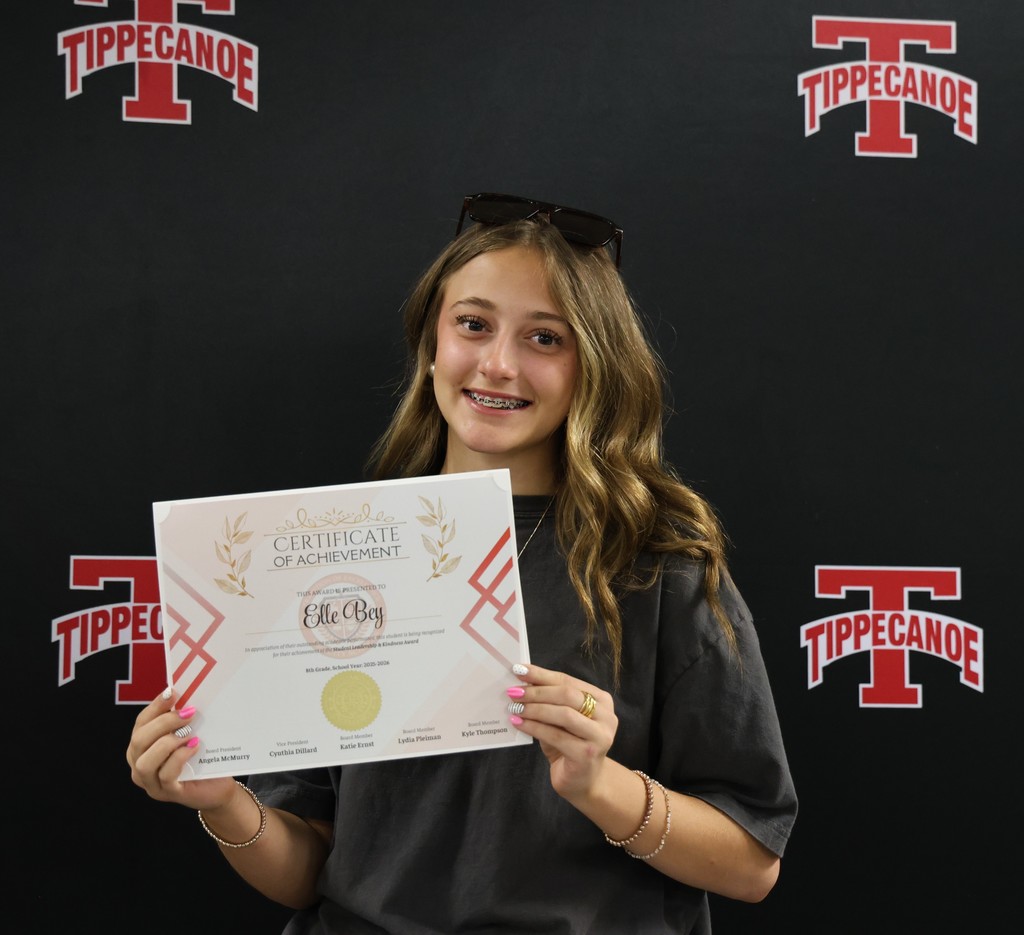 TMS student holds her certificate of achievement after being honored at the monthly BOE meeting.