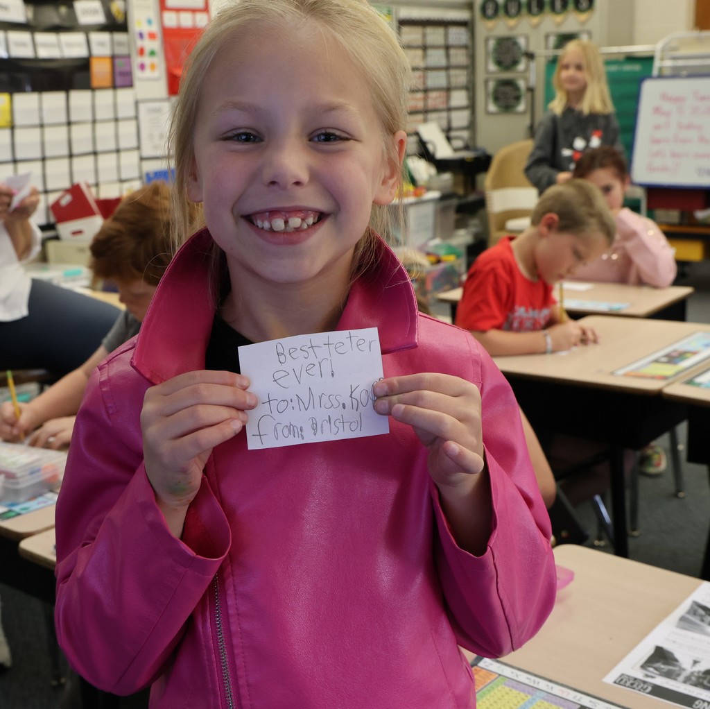 A happy student shows off her little note to the best teacher ever.  
