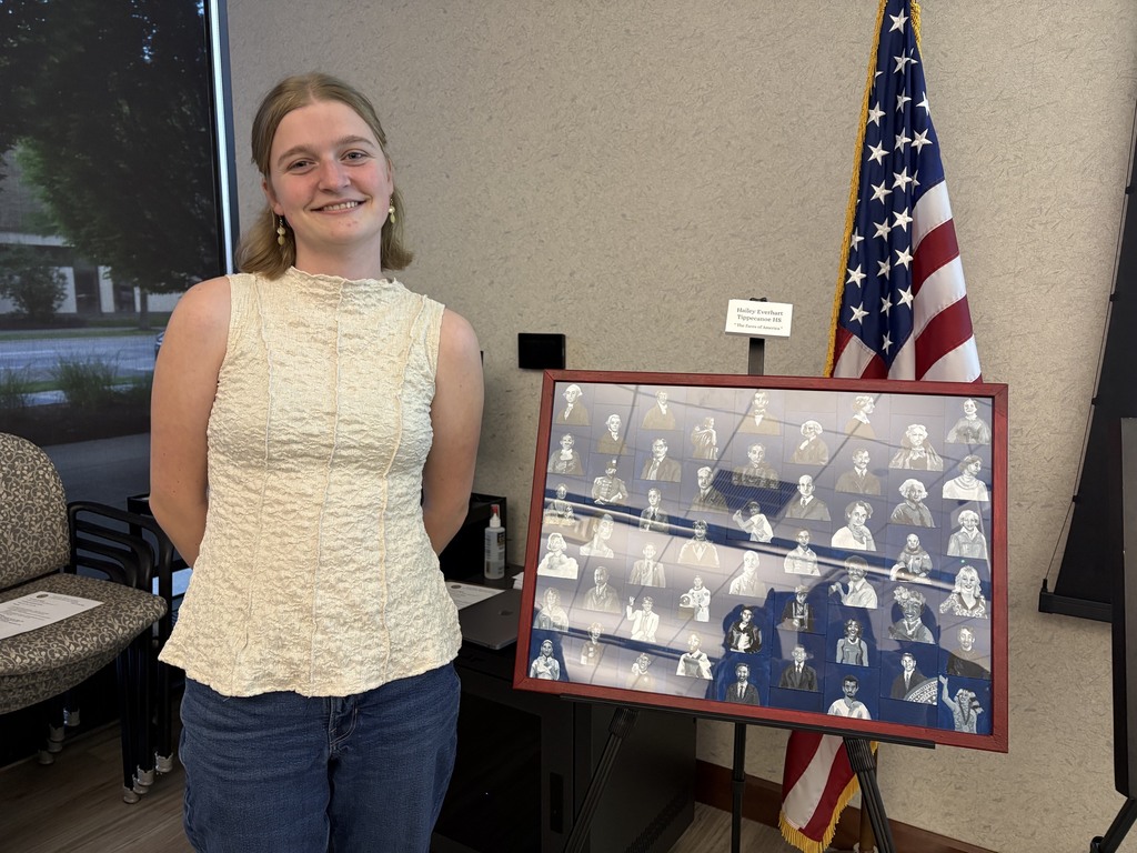 Tippecanoe High School student poses with award winning art work that will be on display on Columbus.
