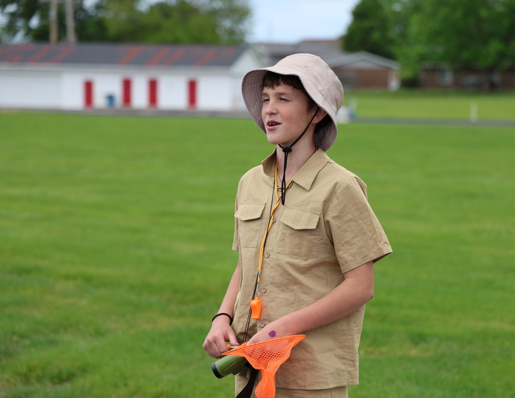 A student gives his presentation at the wax museum.  