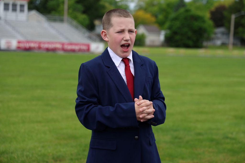 A student dressed in a suit for the Wax Museum.  