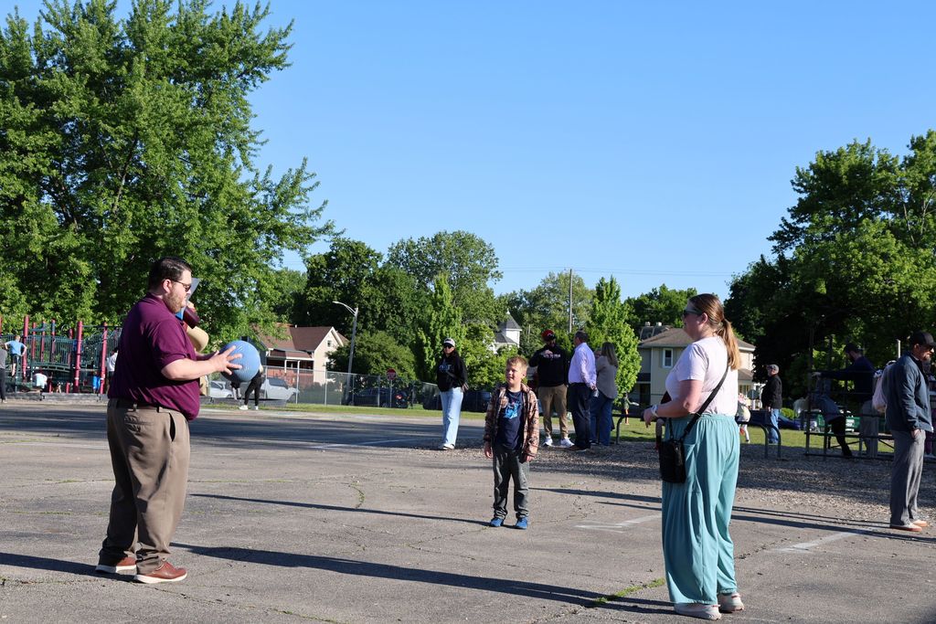 A family plays on the playground during Muffins in the Morning.