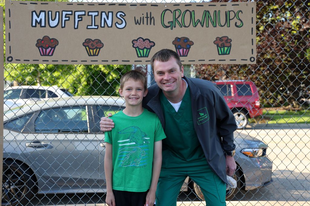 A student and his take pose for a photo at Muffins in the Morning.