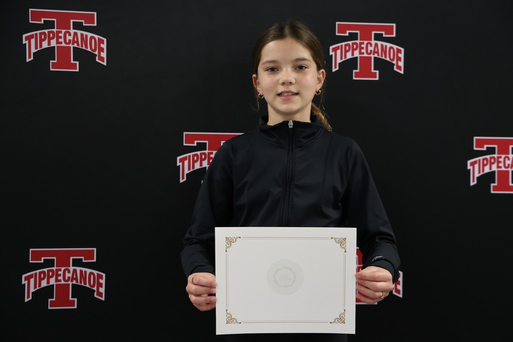 An L.T. Ball 4th grader poses with her certificate from the Board of Education.  