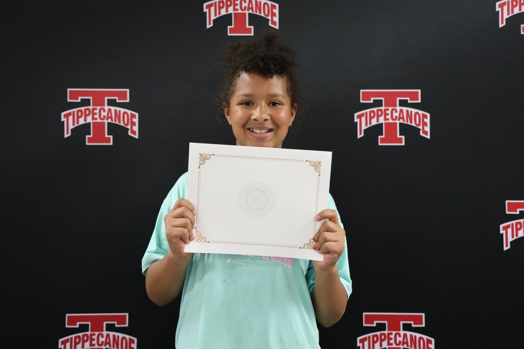 An L.T. Ball 4th grader poses with her certificate from the Board of Education.  