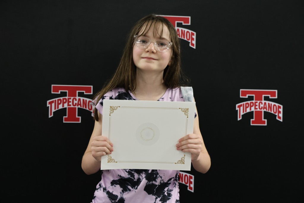 An L.T. Ball 4th grader poses with her certificate from the Board of Education.  