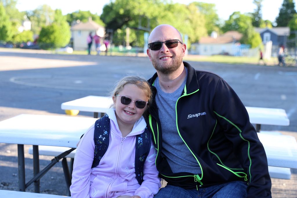 A dad and his daughter pose for a photo at Muffins in the Morning. 