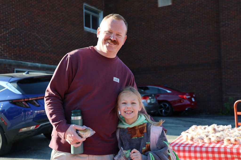 A dad and his first grader at Muffins in the Morning.  