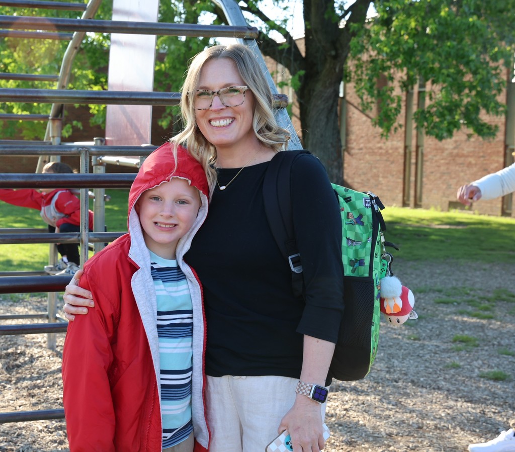 A student and his mom on the playground during Muffins in the Morning.  