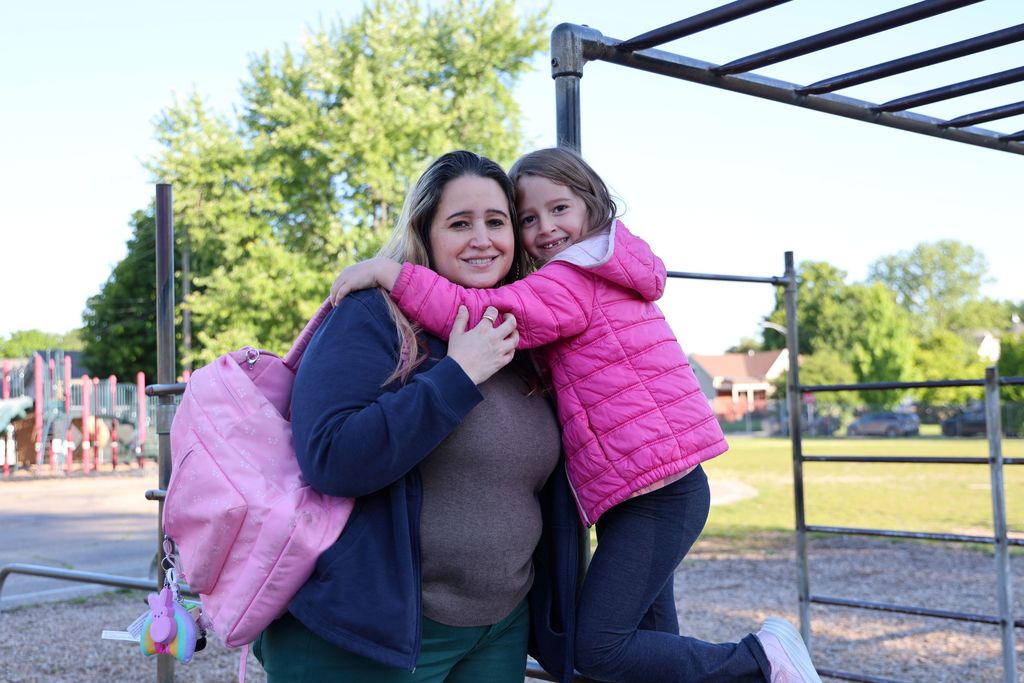 A mom and her daughter on the playground. 