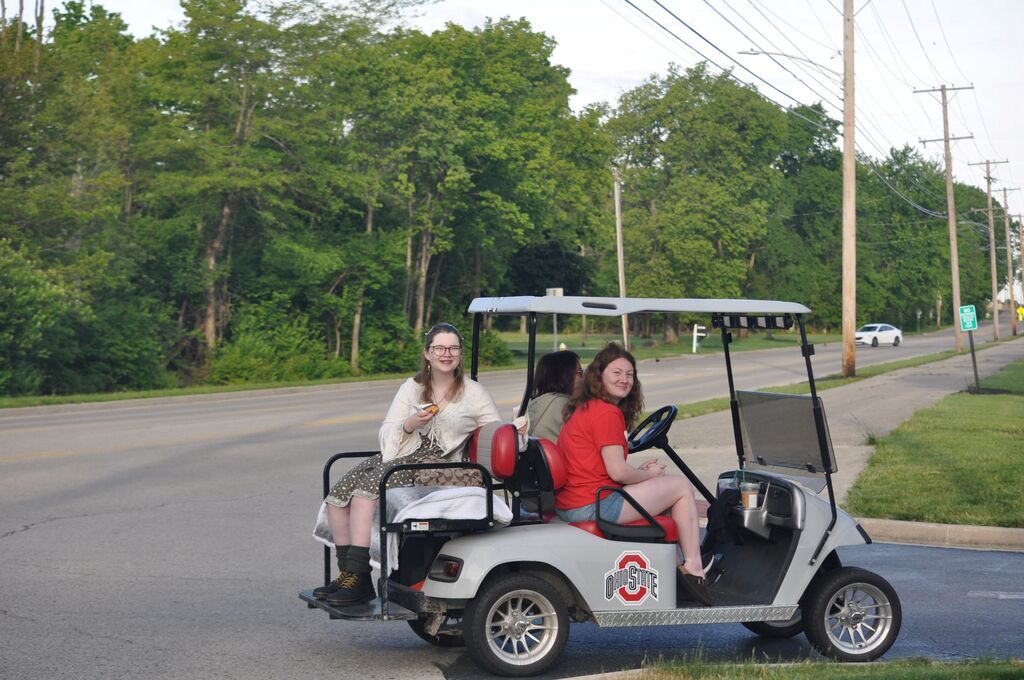 THS students in a golf cart going to school for the last day of classes.