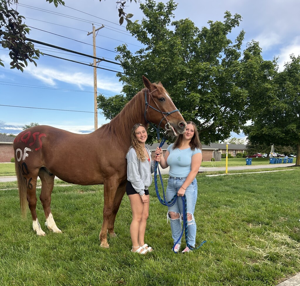 THS students stand with their horse as they wait for the senior parade to start.