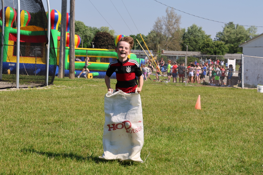 A student races in the sack race.