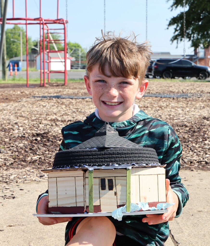 An LT Ball student shows off the Tipp City float created for class.  This is the round house.