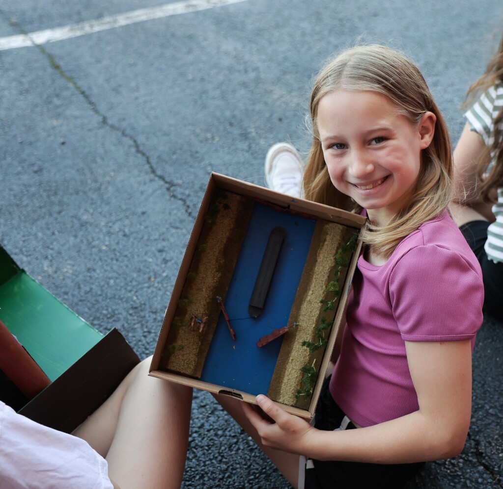 An LT Ball student shows off the Tipp City float created for class.  