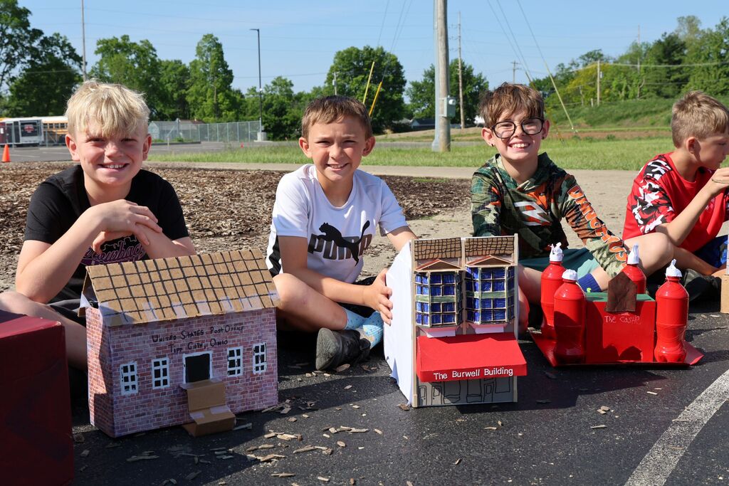 LT Ball students show off the Tipp City floats of The Burwell Building and the castle created for class.  