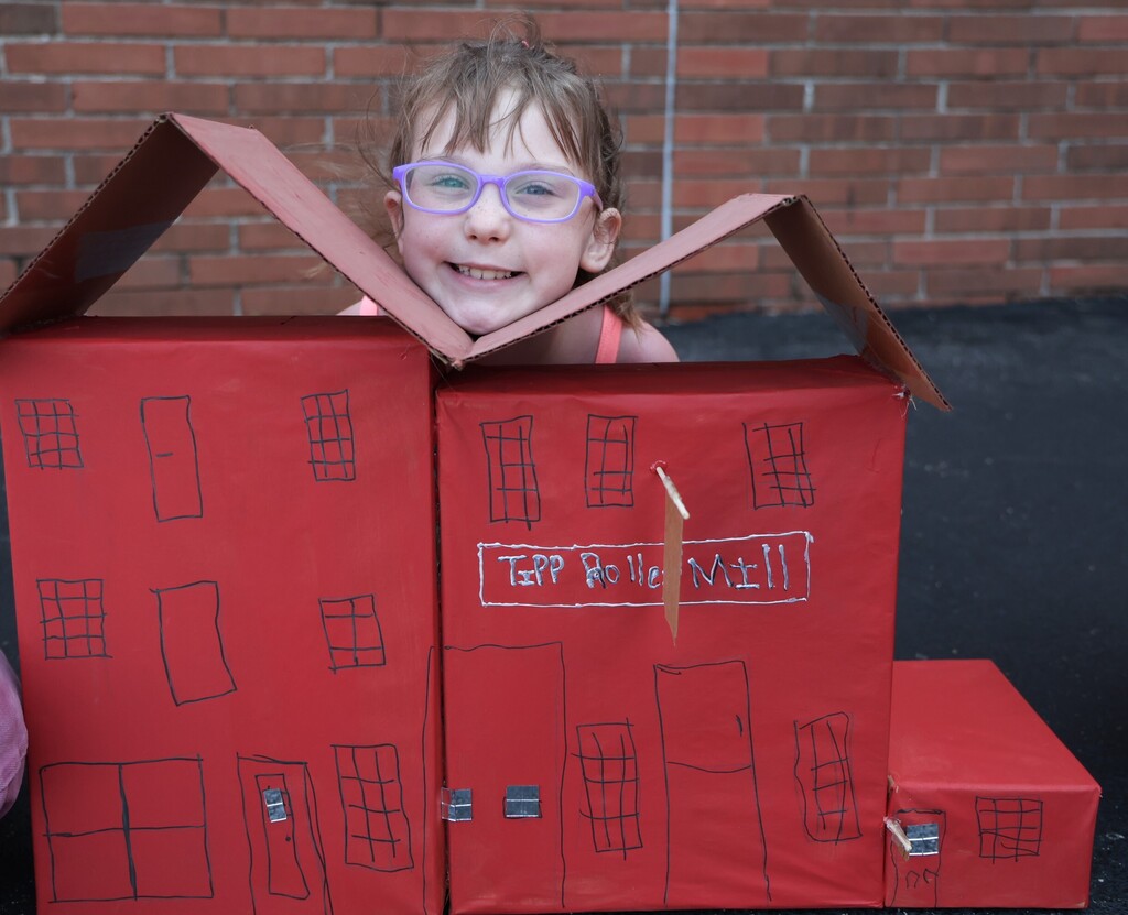 An LT Ball student shows off the Tipp City float created for class.  This is the Tipp Roller Mill.