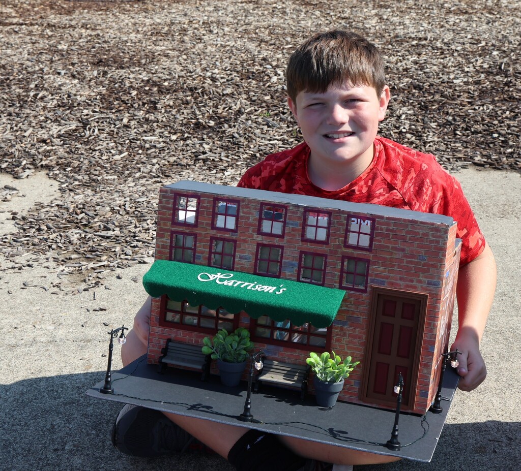 An LT Ball student shows off the Tipp City float of Harrison's created for class.  