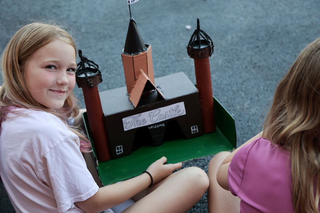 An LT Ball student shows off the Tipp City float of the castle created for class.  