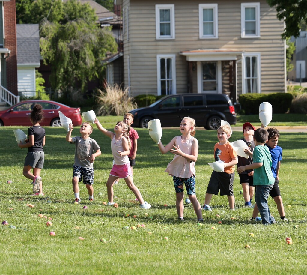 Students test their skills at catching flying balls during field day fun.  