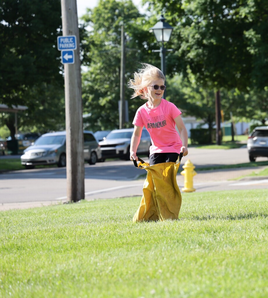 A Broadway students is having a great time racing at field day.