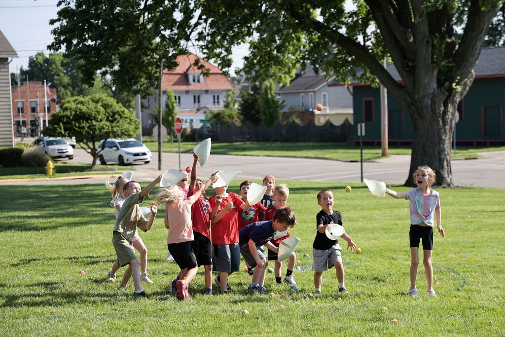 Students test their skills at catching flying balls during field day fun.  