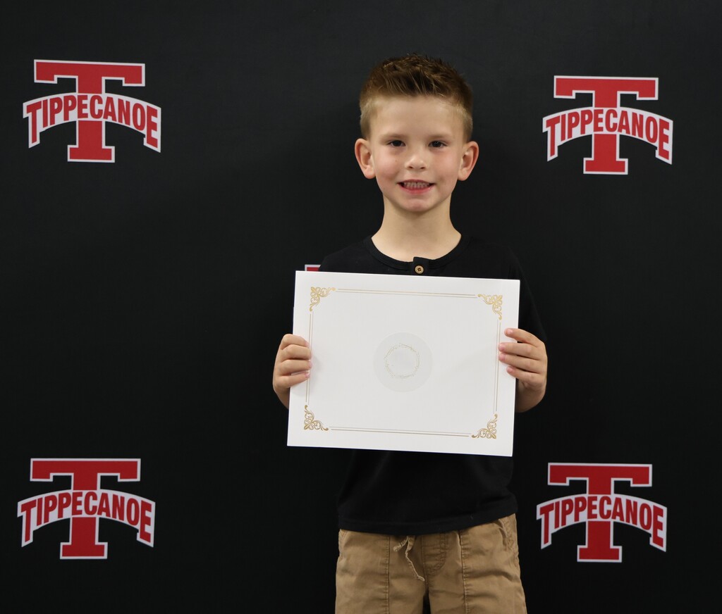 Broadway Elementary student holds his certificate after being honored at the BOE meeting.