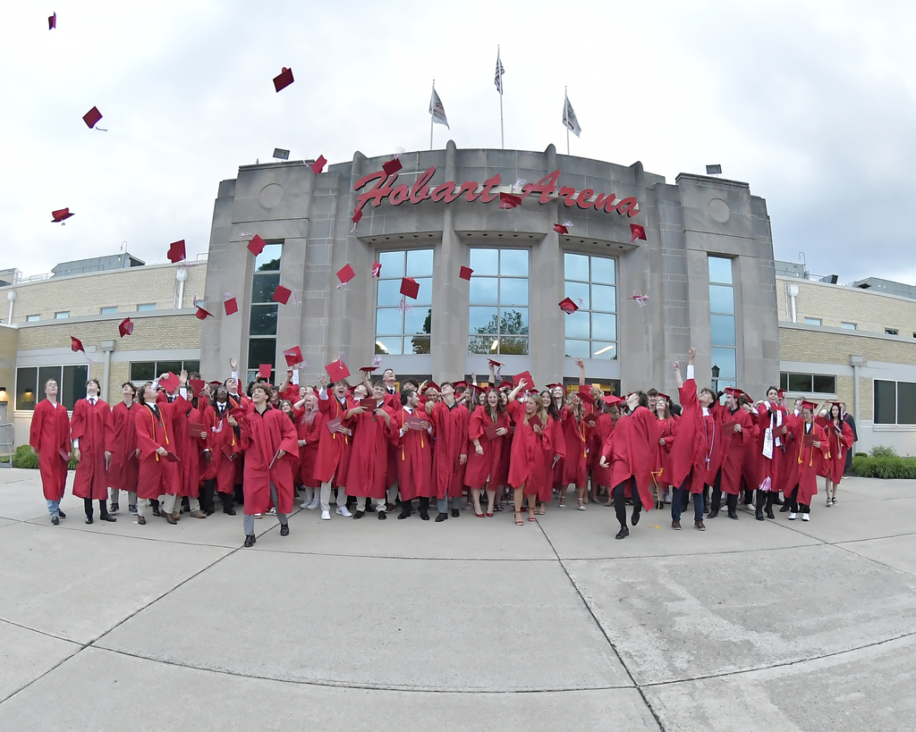 Class of 2026 outside after graduation with the cap toss.  