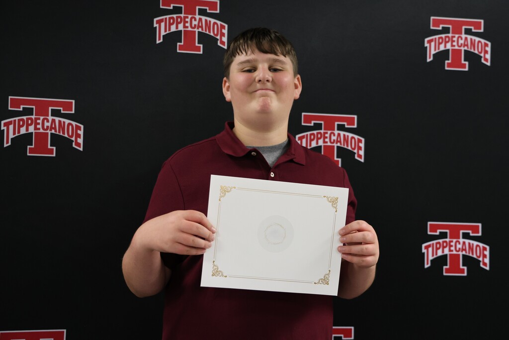 Tippecanoe Middle School student with his certificate after being honored at the Board of Education meeting.