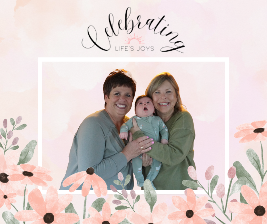 Celebrating life's joys.  Two staff members, whose children are married, are grandparents and cuddling the bundle of joy/
