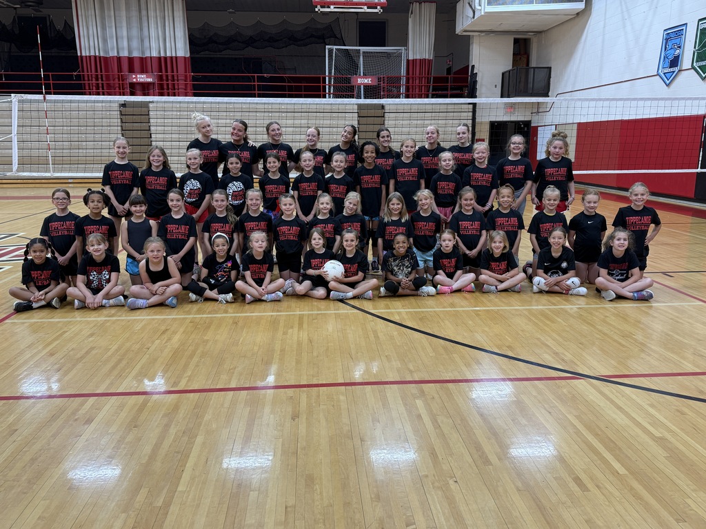 Rising 2nd to 4th graders who attended a TMS volleyball camp pose for a group picture with the student volunteers.
