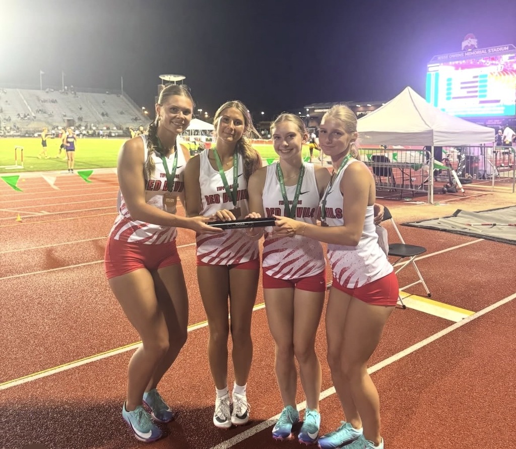 THS 4x200 relay team holds the baton after winning the race in 4th place.
