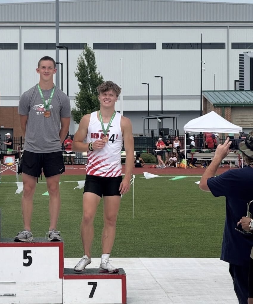 THS students on the podium after the long jumps at State Track and Field.